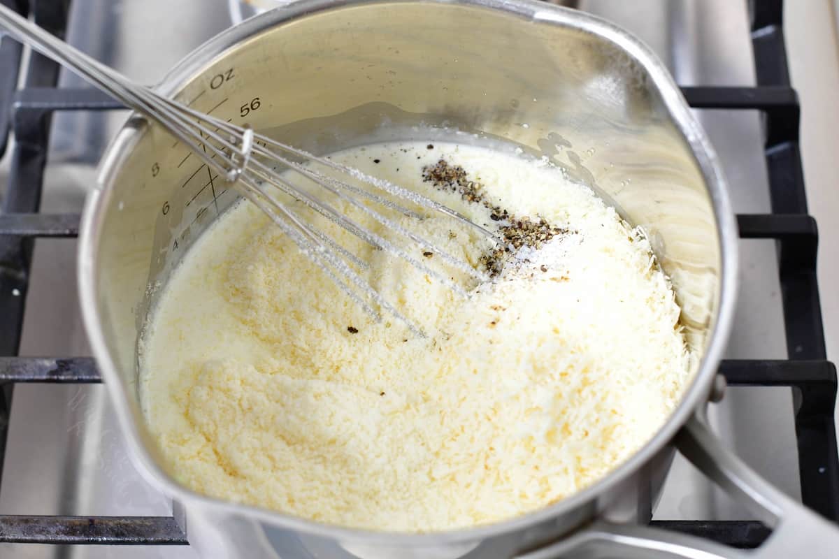 stirring in parmesan cheese and seasoning into heavy whipping cream.