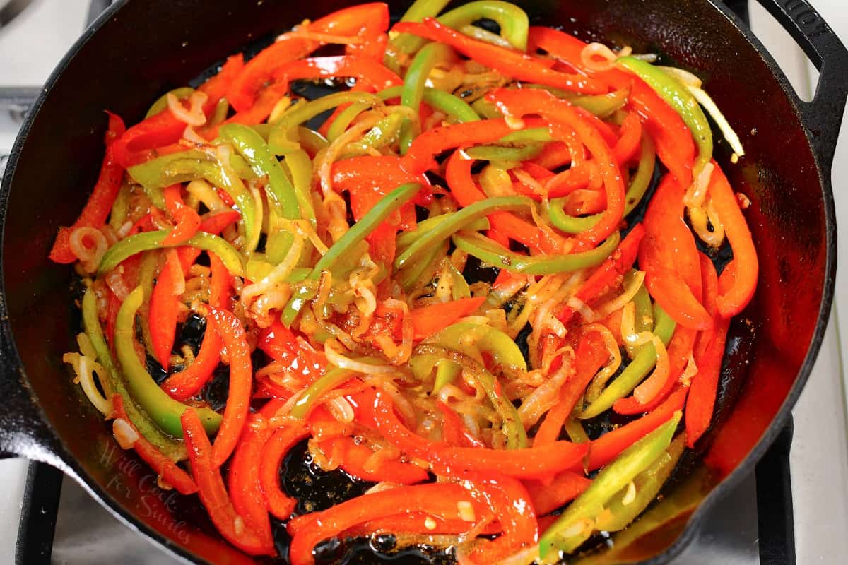 Peppers and onions are cooked in the marinade.