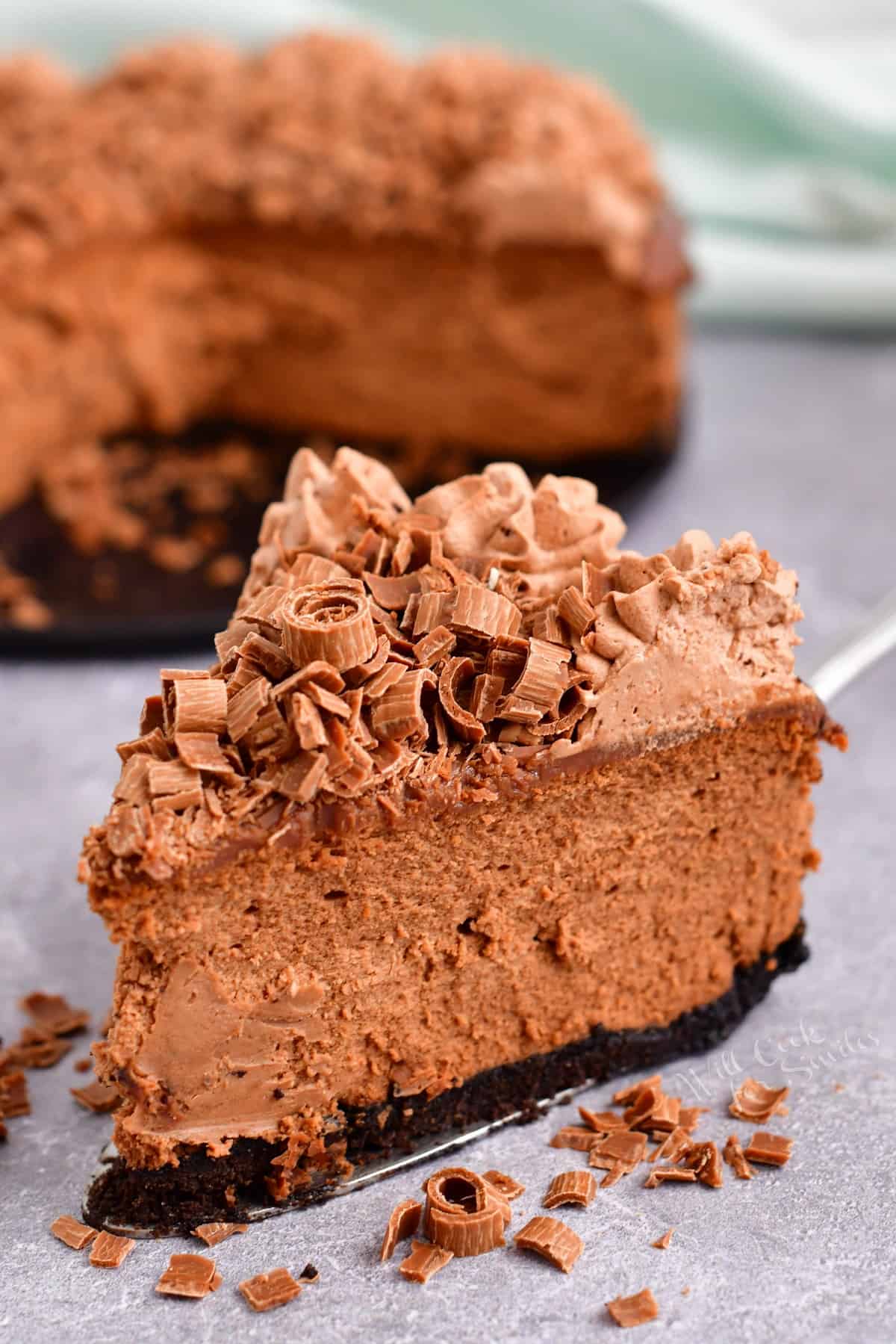 A slice of chocolate cheesecake is read to be eaten. 