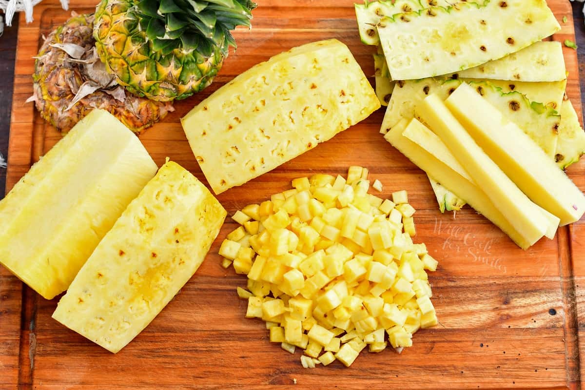 The ingredients for pineapple salsa are placed on a wooden cutting board.