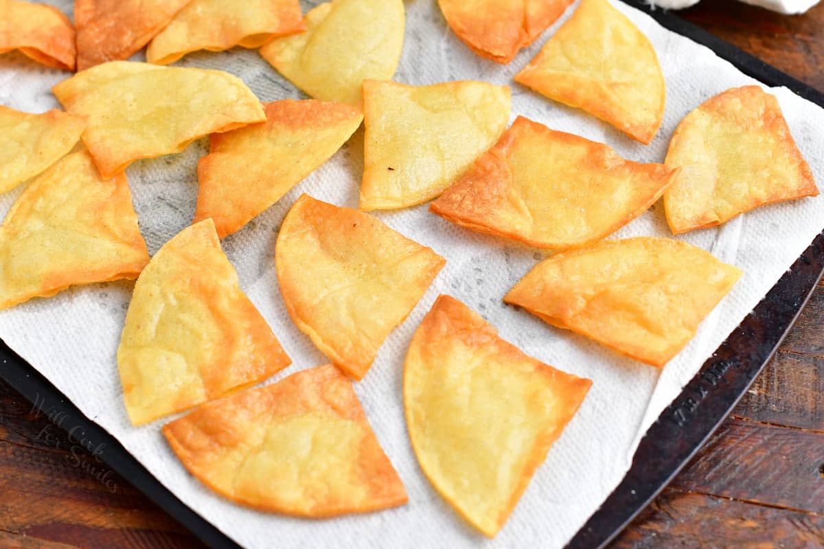 Chips are being baked on a prepared baking sheet.