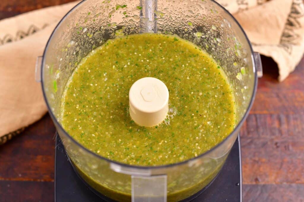 Salsa has been thoroughly blended in a large blender.