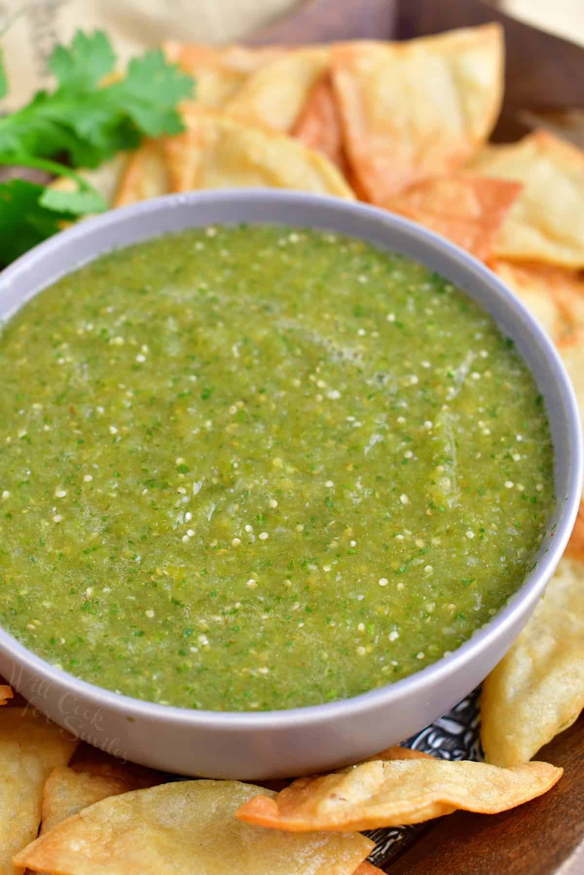 A large white bowl contains a heaping portion of salsa verde.
