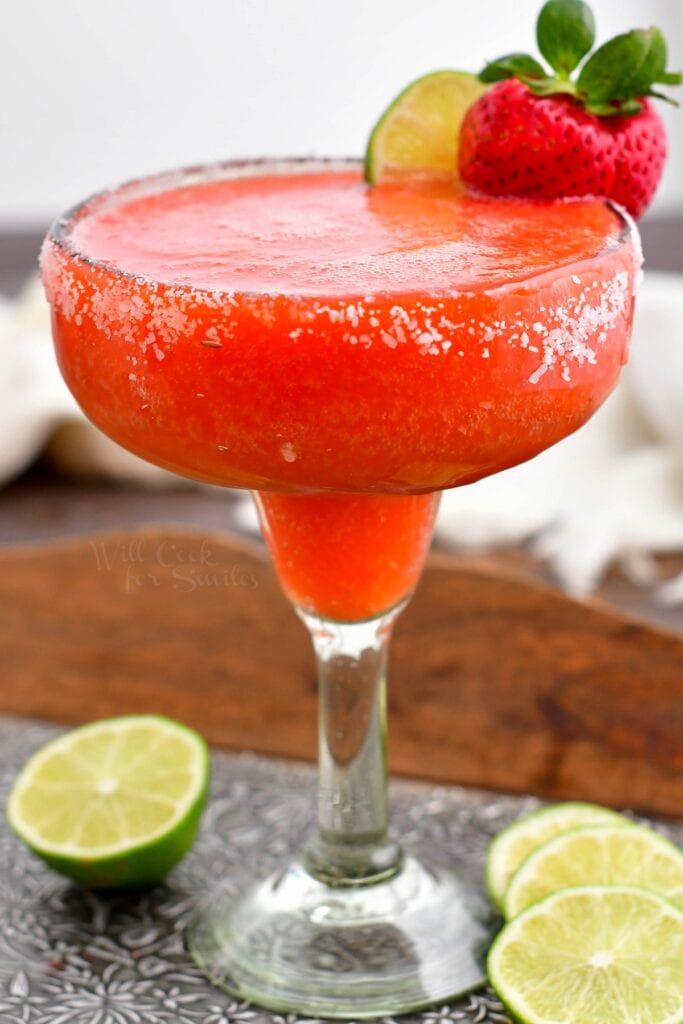 A full glass of chilled strawberry margarita is ready to be enjoyed.