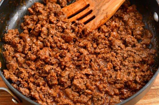 Cooked ground beef is in a large skillet.