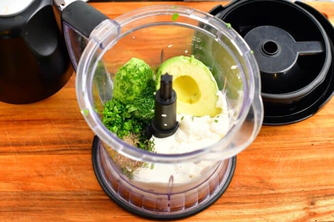 The ingredients for avocado ranch are in a blender. 