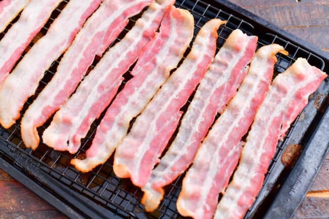 Bacon is placed on a wire rack.
