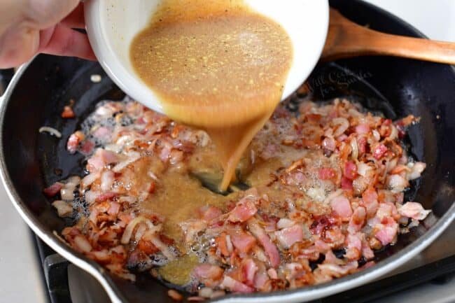 A tangy mixture is being poured onto the cooking bacon. 