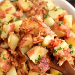 Bacon, parsley, and dressing are tossed with potatoes.