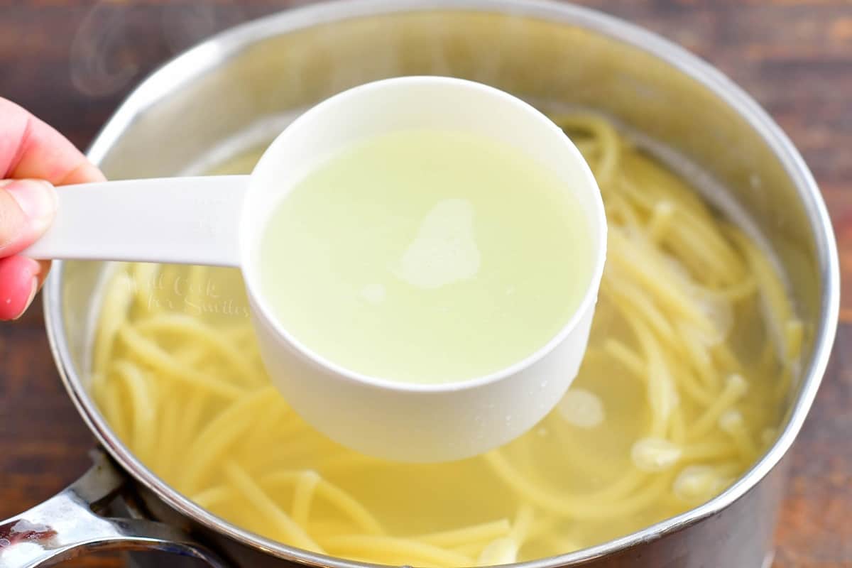 Pasta water is being removed from the pot. 