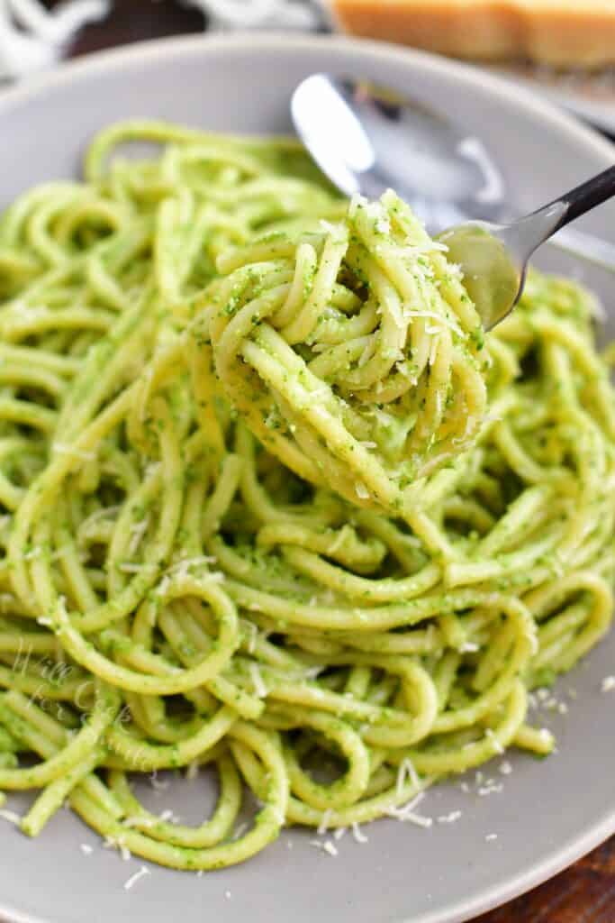 A fork is twirling a bite of pasta.