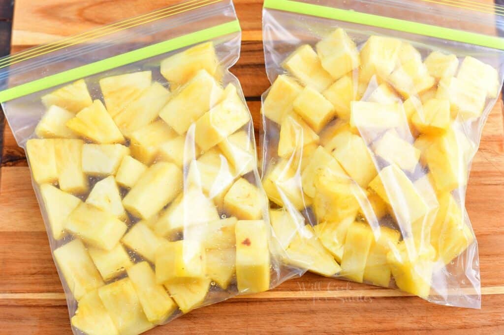 Pineapple chunks are placed in two ziplock baggies.