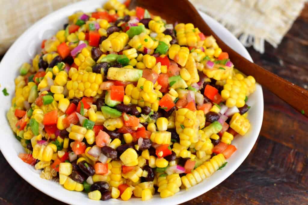 Black bean and corn salad is on a large white plate. 