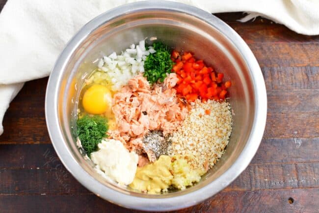 The ingredients for patties are in a large silver bowl. 