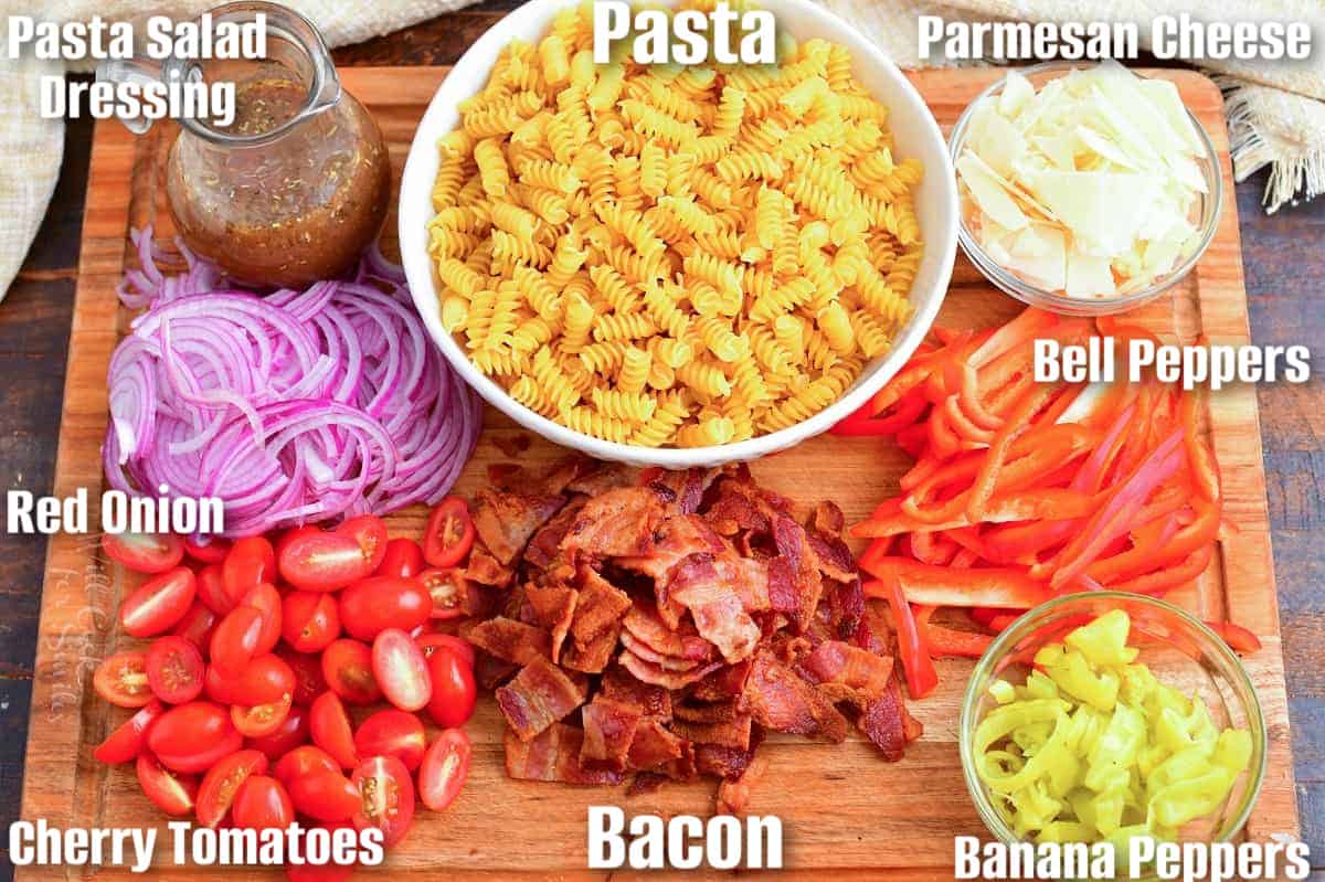 Ingredients to make our favorite pasta salad in a cutting board.