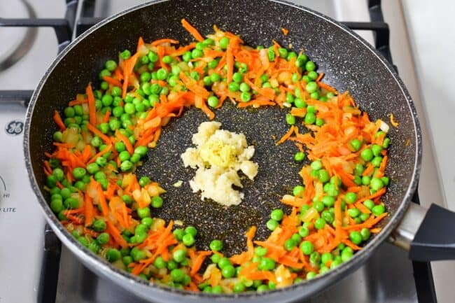 Garlic is in the center of the pan.