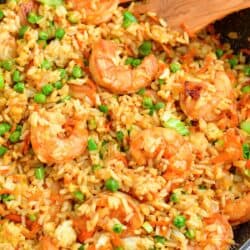 Shrimp fried rice has been cooked in a black skillet and is ready to serve.