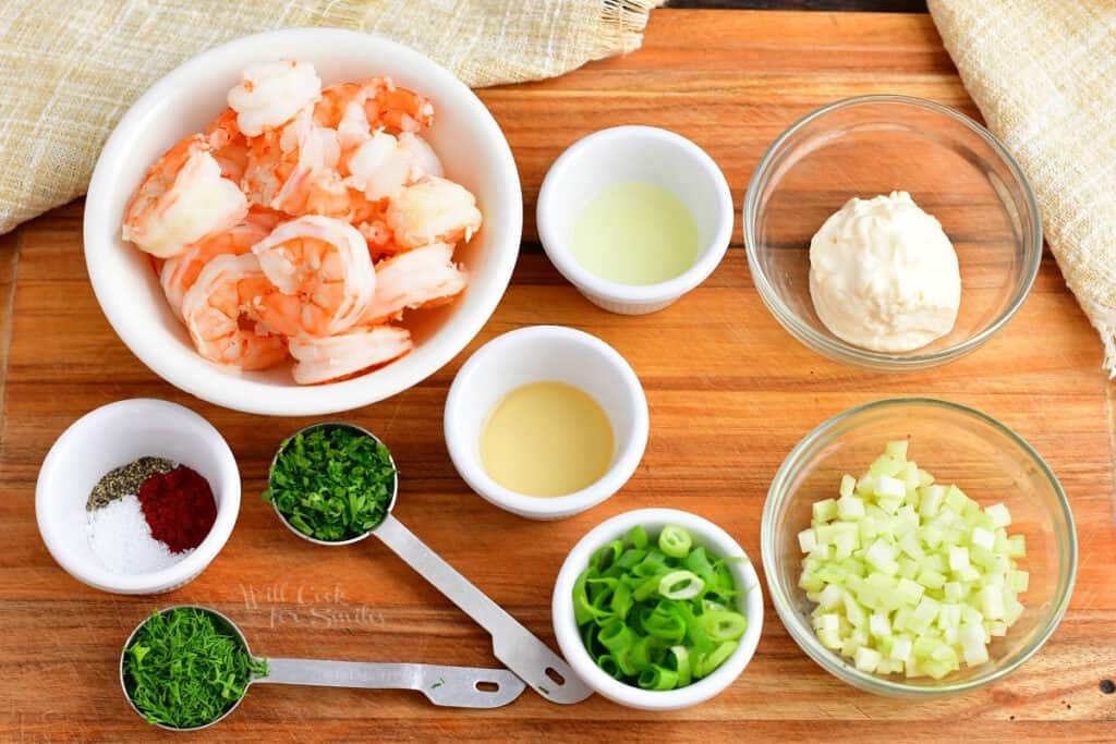 Shrimp Roll Ingredients are on a wooden surface. 