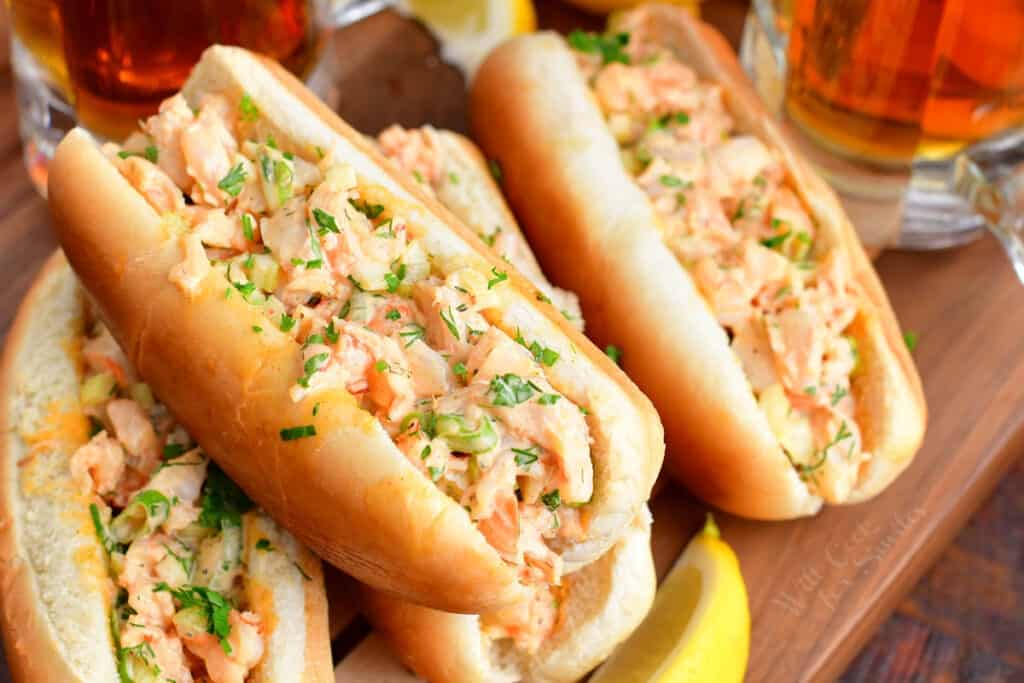 Stuffed hot dog buns are filled with shrimp salad. 