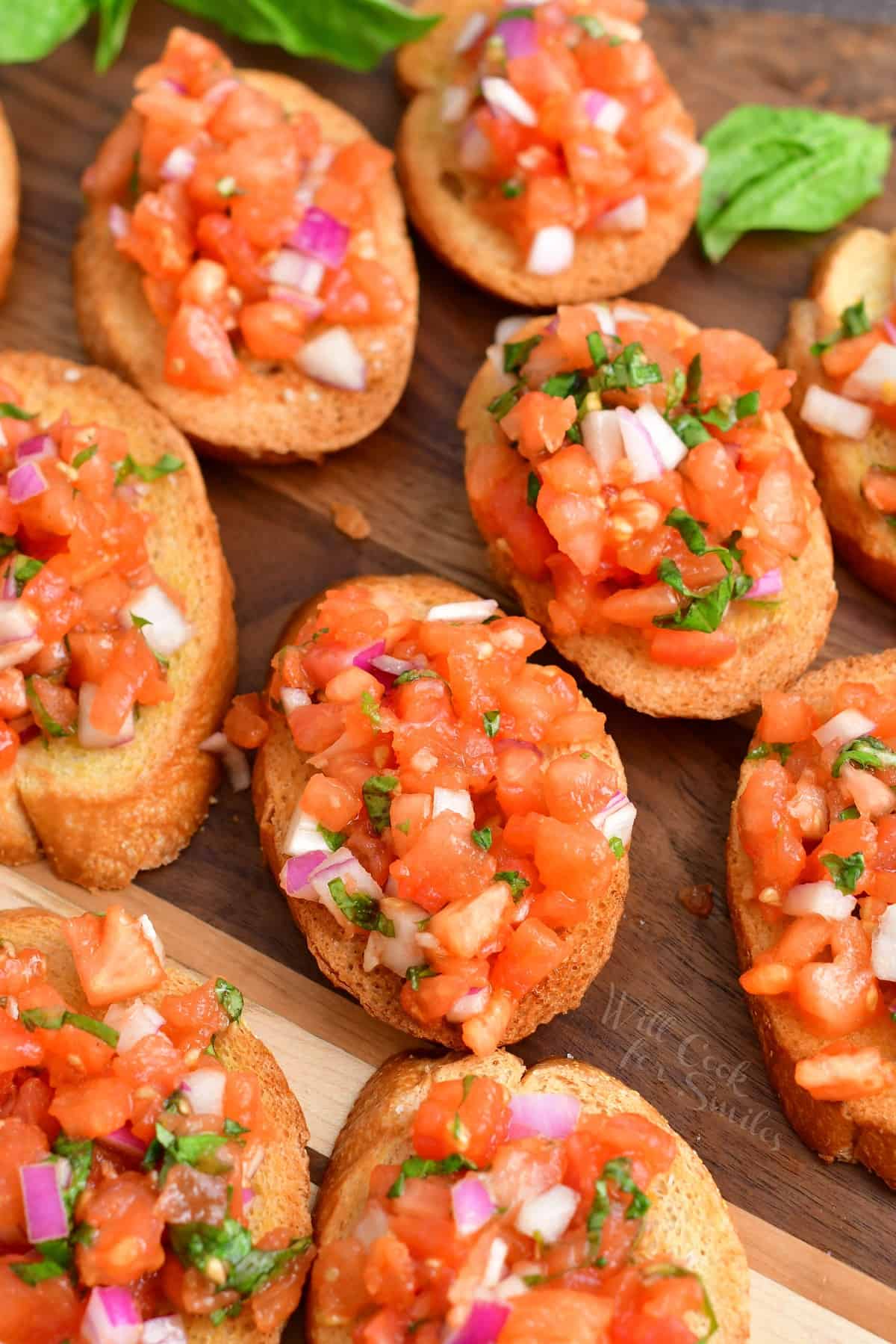 closeup of bruschetta: sliced of baguette with diced tomato mixture
