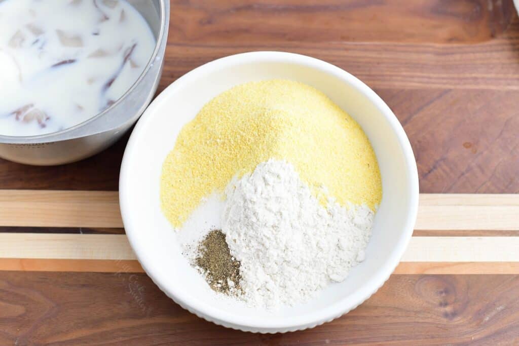 A flour mixture is presented in a white bowl. 