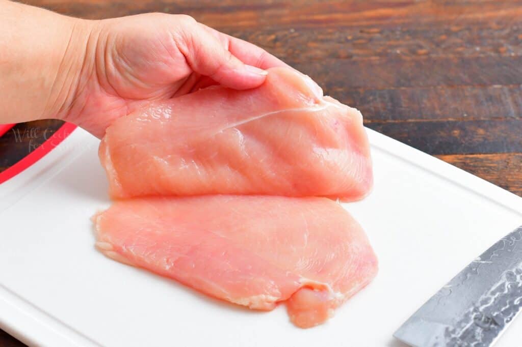 A chicken breast has been sliced in half.