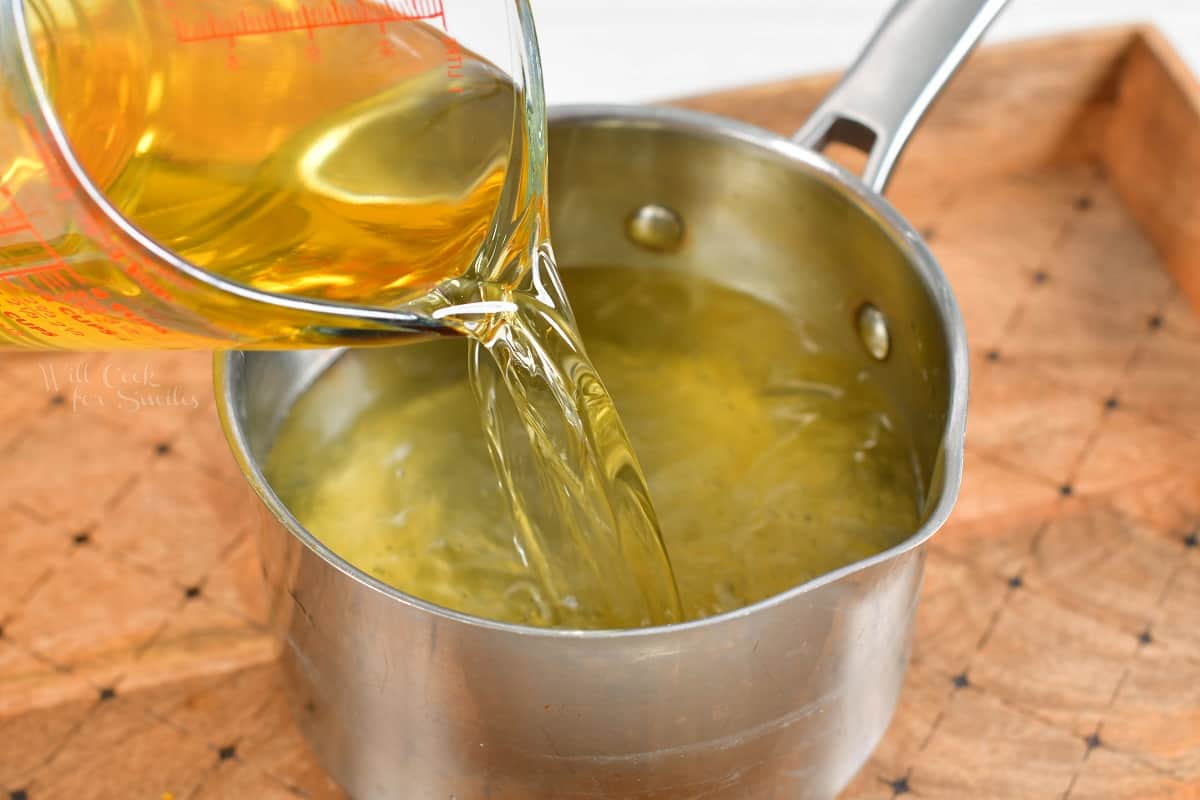 The lemon vodka is being poured into a pot.