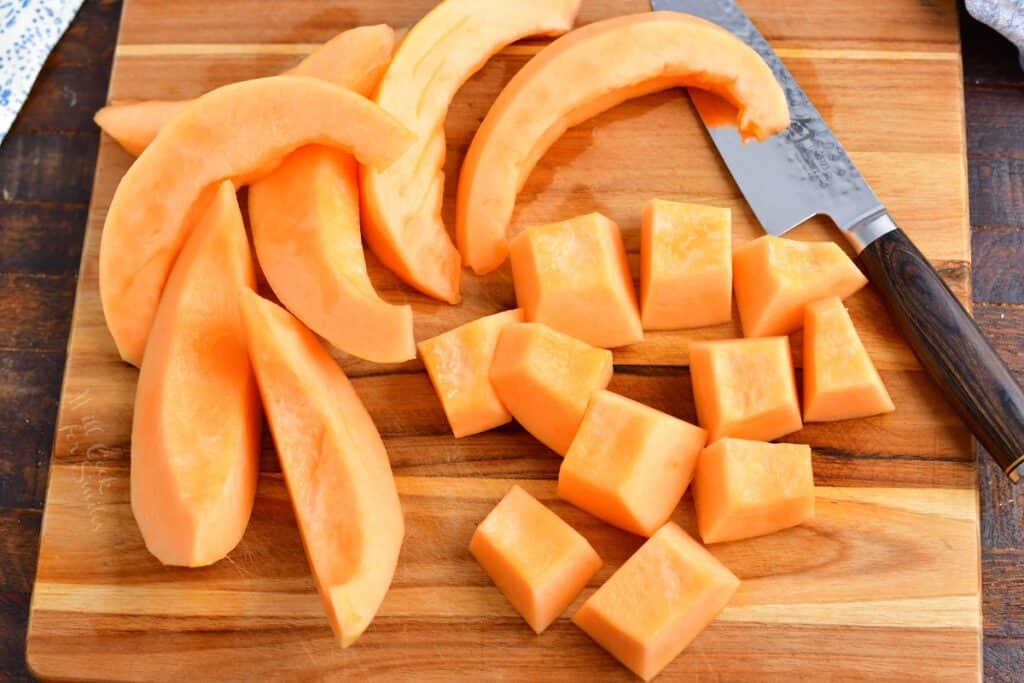 sliced and cut cantaloupe melon on a cutting board