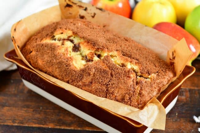 Apple bread is baked in a prepared baking dish.