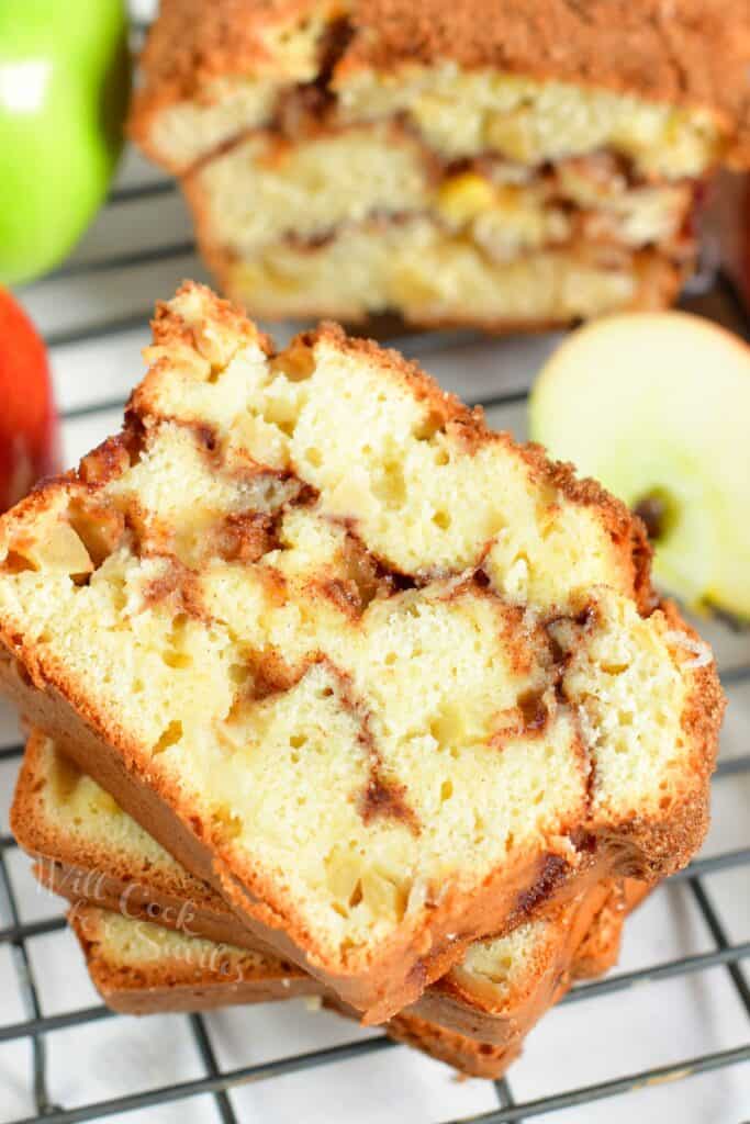 Slices of apple bread are placed on a wire cooling rack.