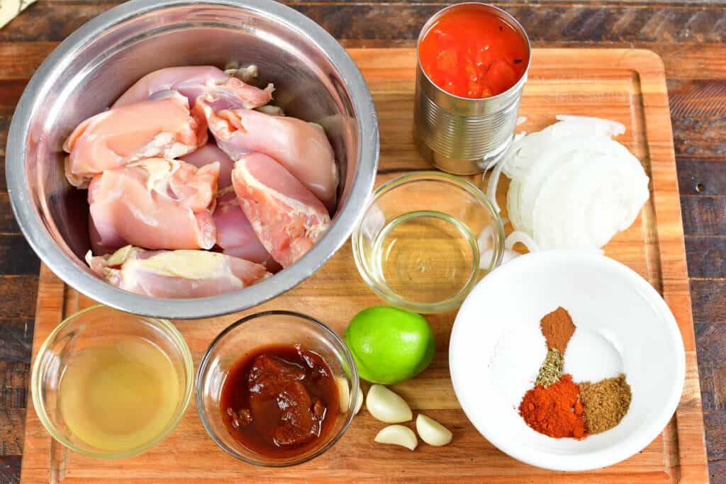 ingredients for the shredded chicken tacos on a cutting board
