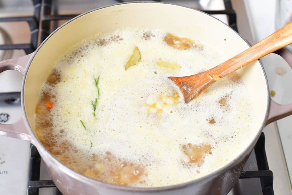 A boiling mixture is presented on a stovetop.