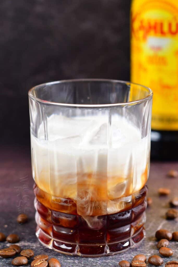 white Russian cocktail in a glass before mixing it to make creamy, layered look