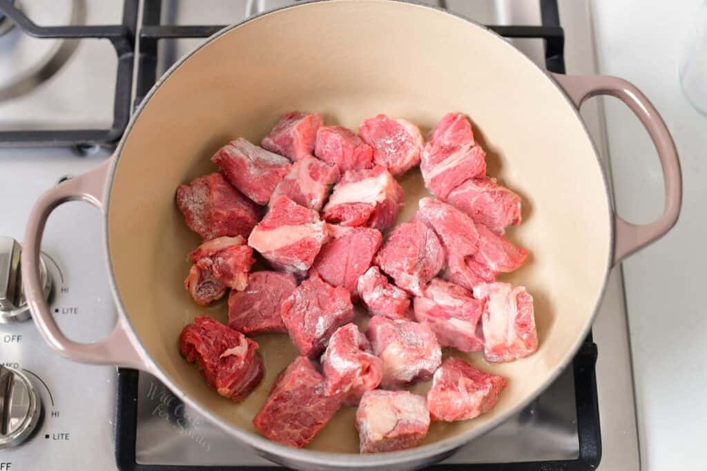 beef pieces searing in a Dutch Oven