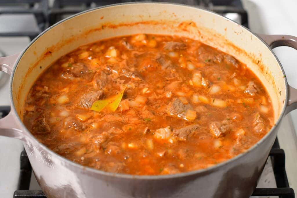 beef stew simmering in a pot on a stove