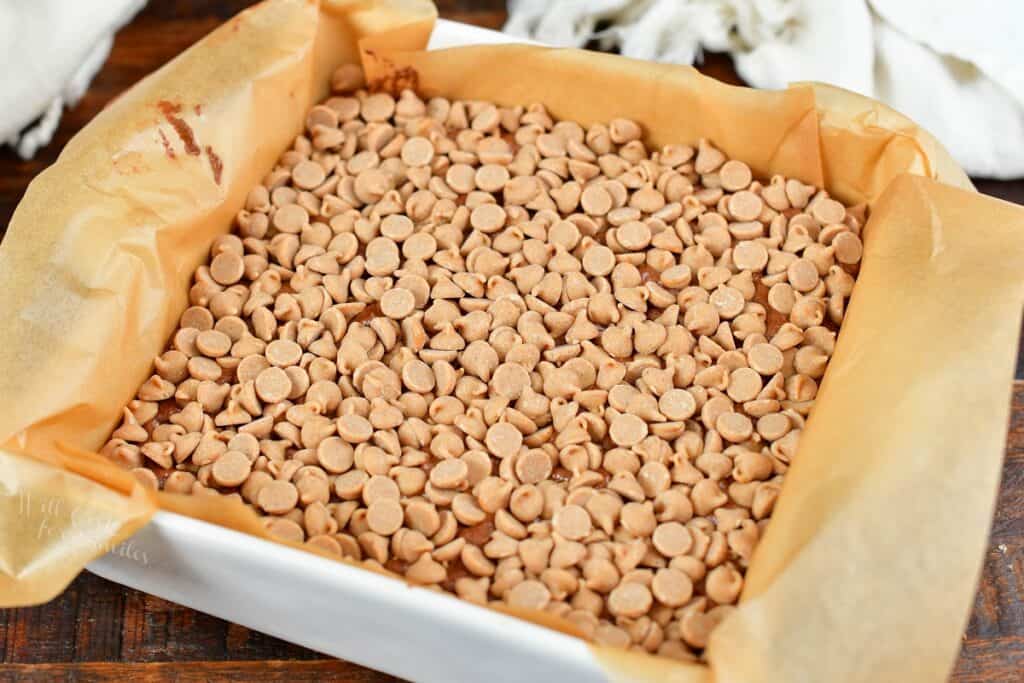 fudge topped with peanut butter chips in a baking dish