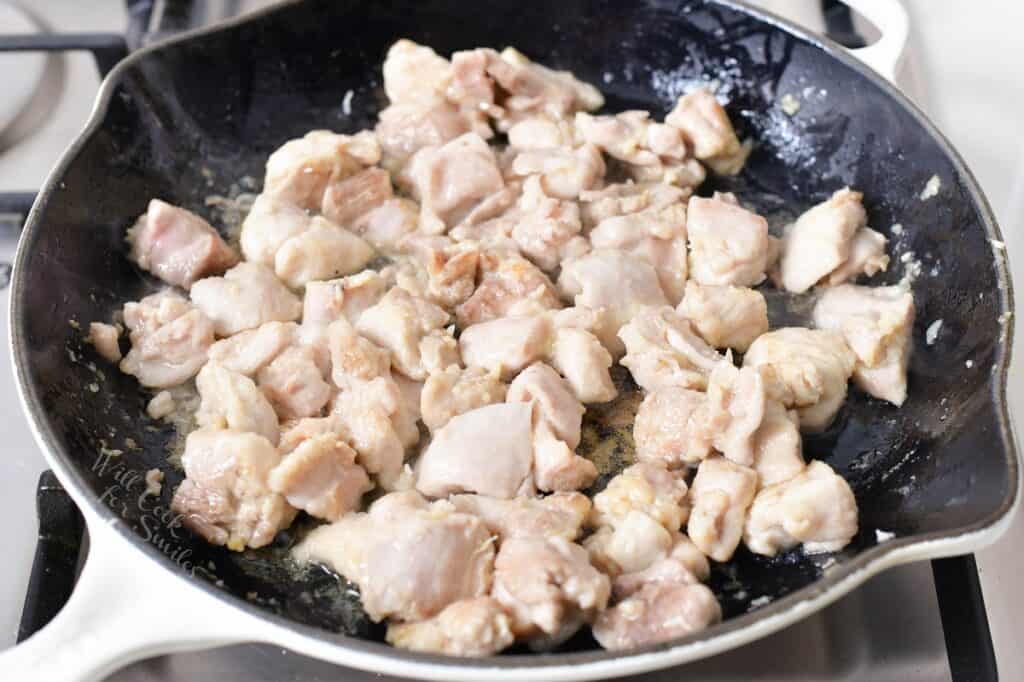 chicken thigh meat cooking in a pan
