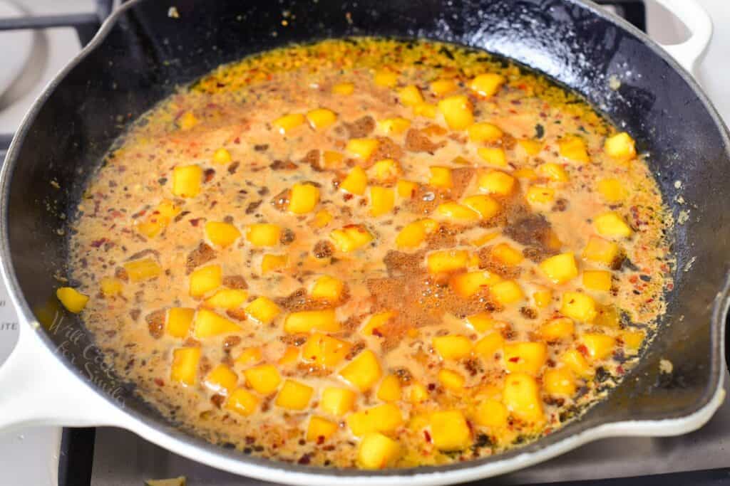 Mango sauce simmering in a pan