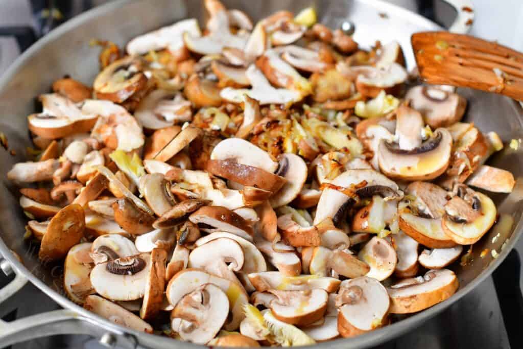 mushrooms uncooked added to the metal pan