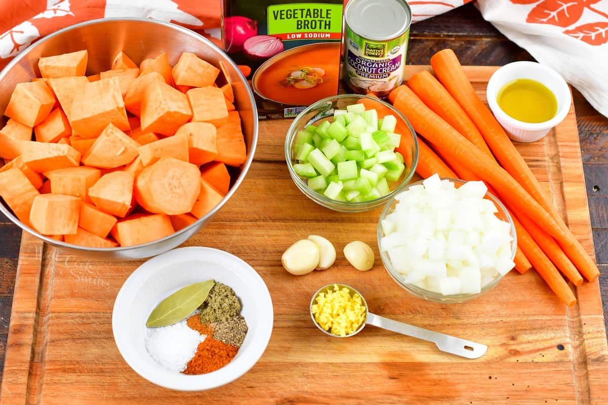 ingredients for sweet potato soup on a cutting board.