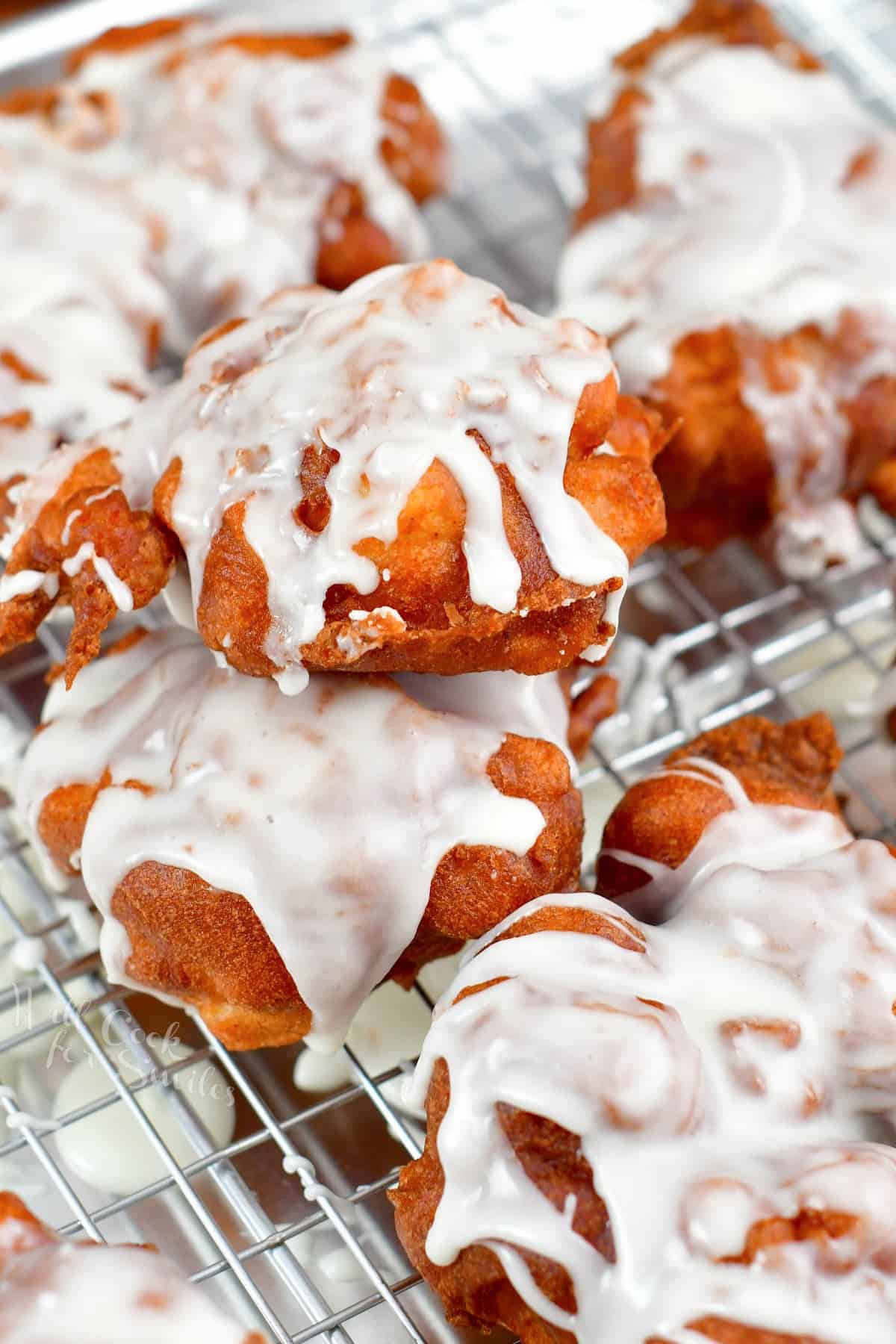 stacked apple fritters on the wire rack