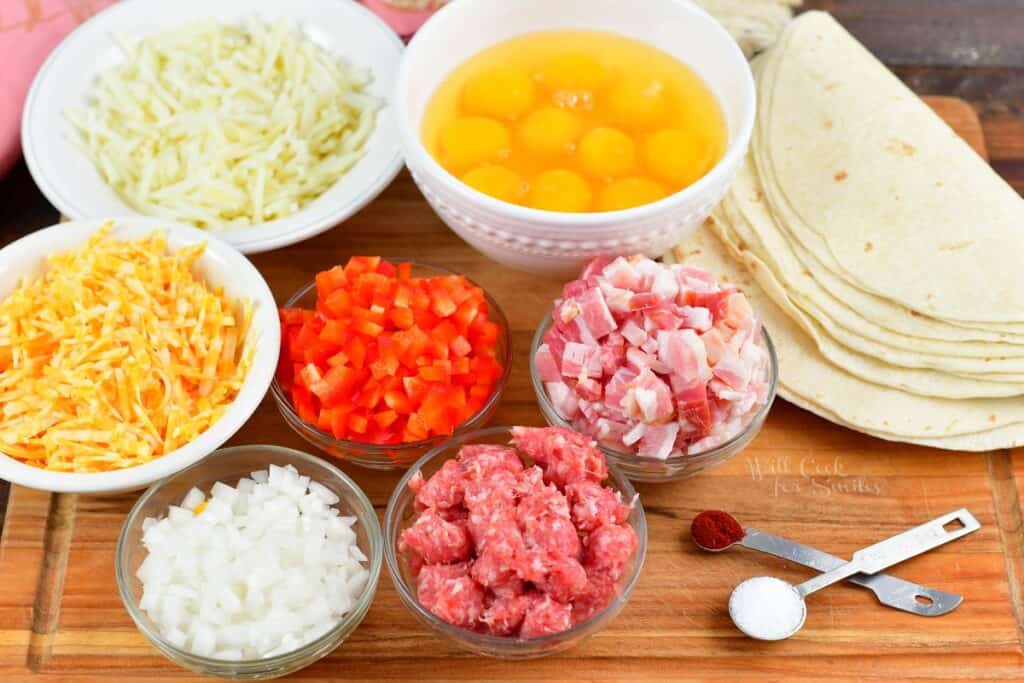 ingredients for breakfast burritos on a cutting board