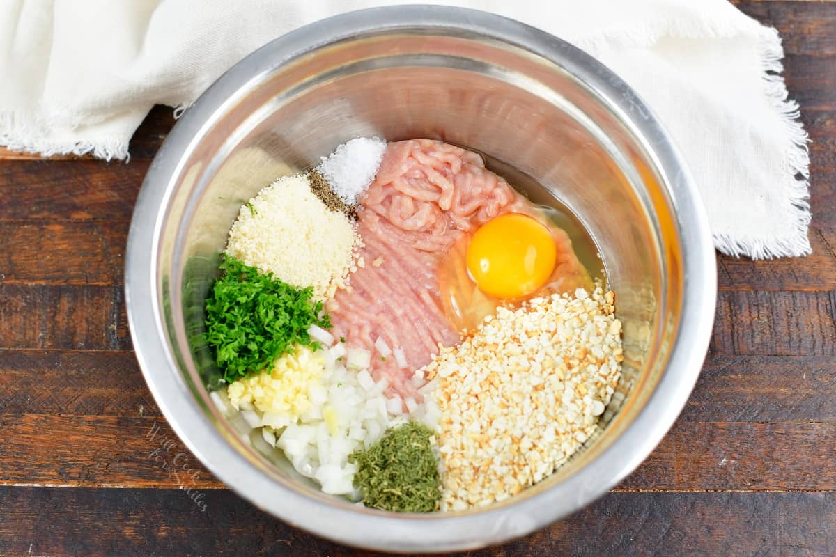 ingredients for chicken meatballs laid next to each other in a bowl 