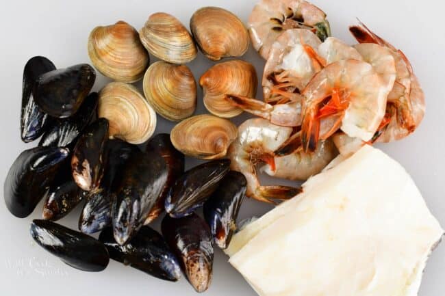 seafood for Cioppino including white fish, clams, mussels, and shrimp