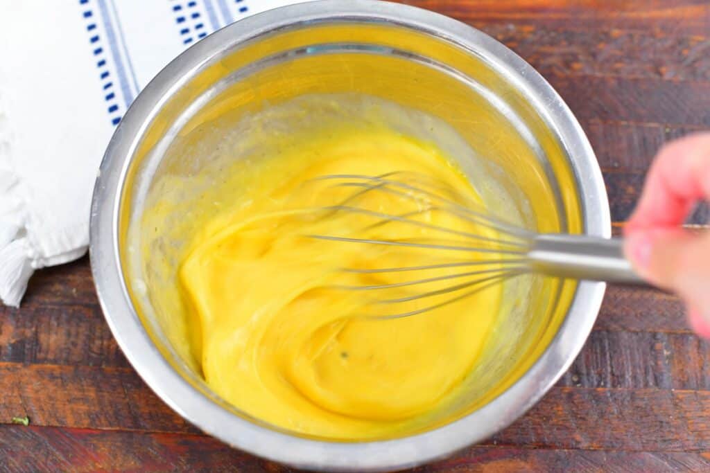 whisking eggs in a metal bowl