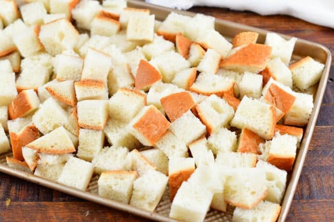 cut up bread cubes spread on a sheet tray