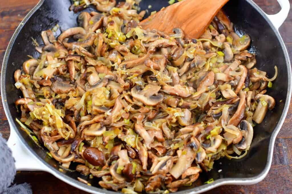 sautéed mushrooms and leeks in a pan