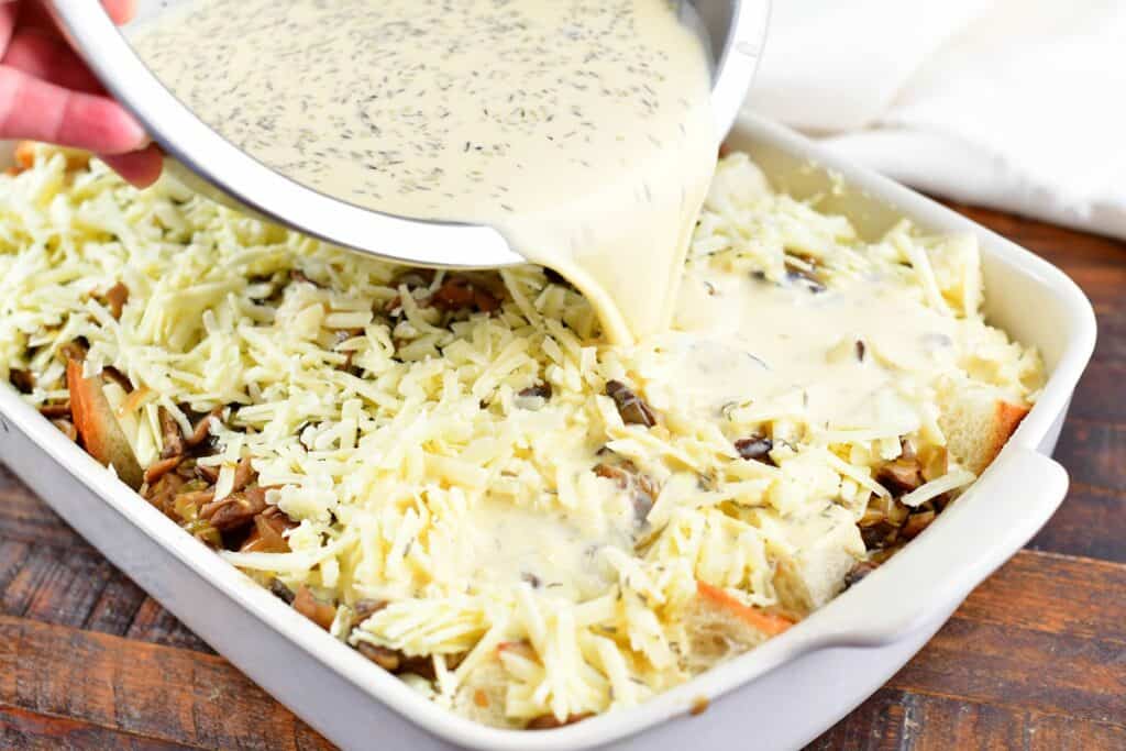 adding egg mixture into the bread pudding ingredients in the pan