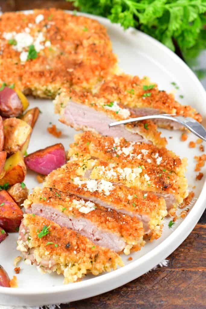 sliced pork cutlet with a fork through one slice