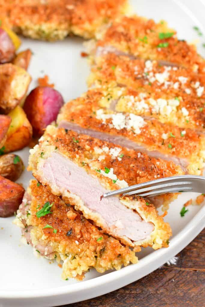 sliced crispy pork cutlet and one slice close up